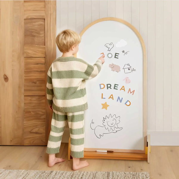 Child drawing on the chalkboard side of the Tiny Land double-sided easel
