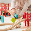 Child playing with a wooden train set on a light surface