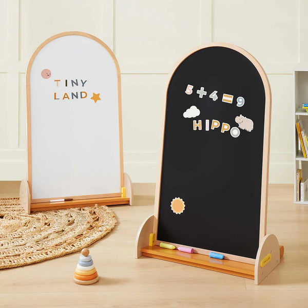 Tiny Land double-sided magnetic chalkboard easel with beechwood frame in a child's playroom