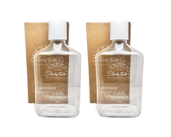 Two bottles of Lucky Teeth mouthwash with packaging on a white background