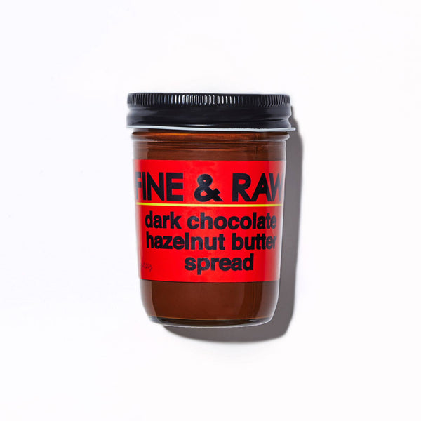 Jar of dark chocolate hazelnut butter spread with a red label on a white background