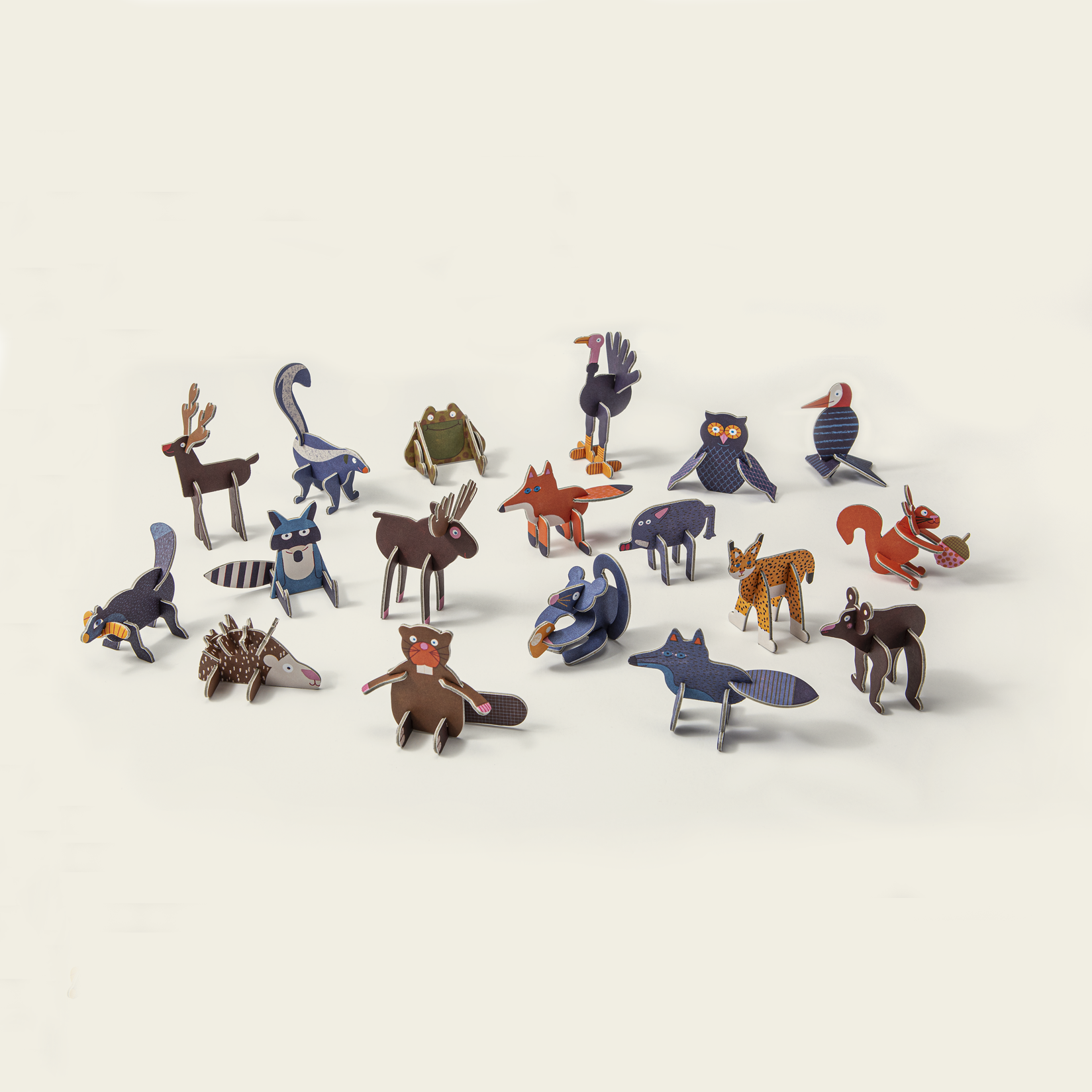 Set of small animal figurines on a light beige background