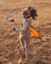 Person in a costume with wings running through a field