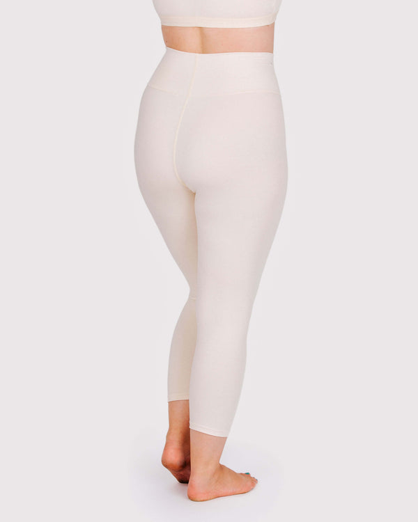 Woman wearing Thunderpants High Rise Ankle Length Leggings in Pomegranate Punch, back view