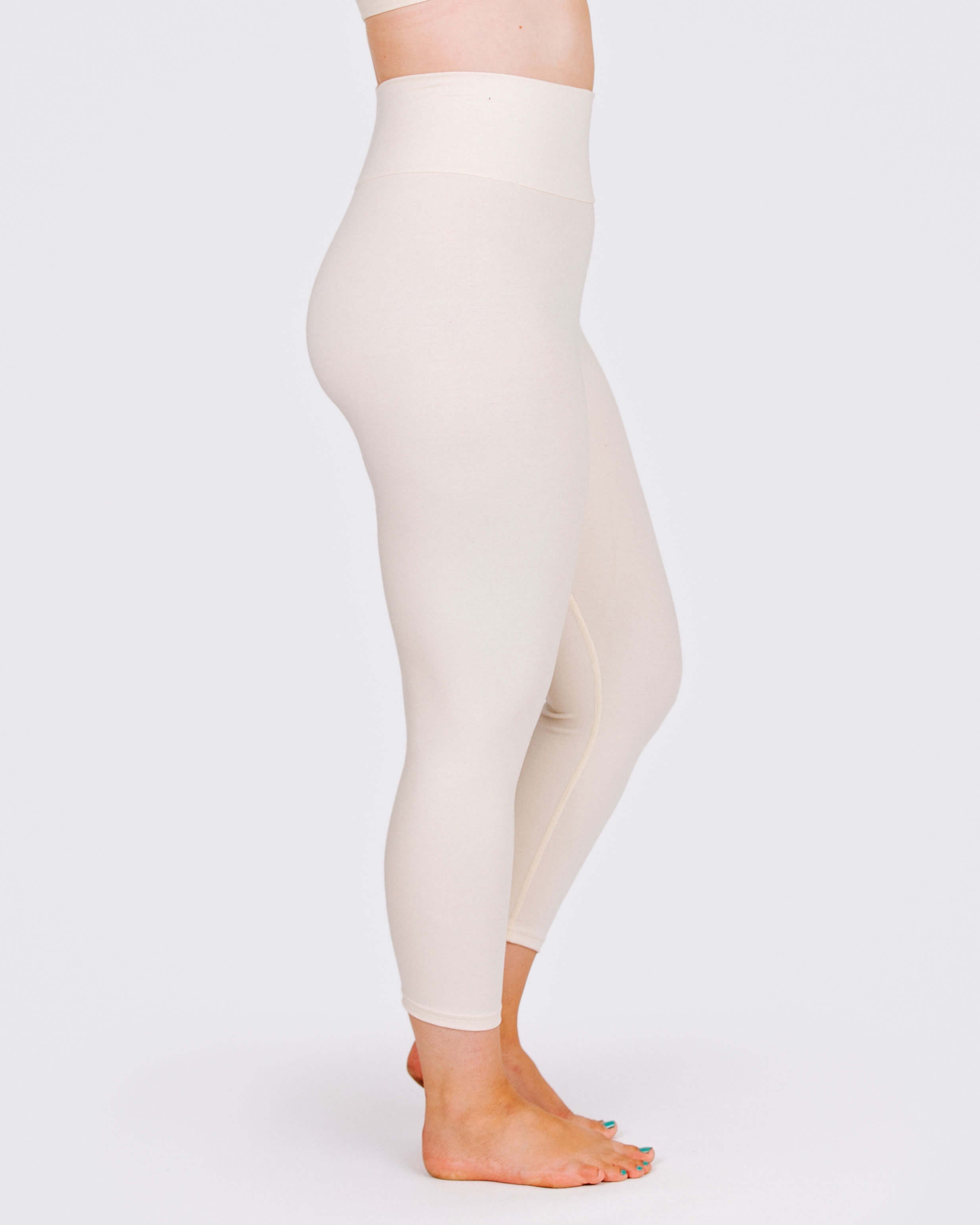 Woman wearing Thunderpants High Rise Ankle Length Leggings in Pomegranate Punch, side view