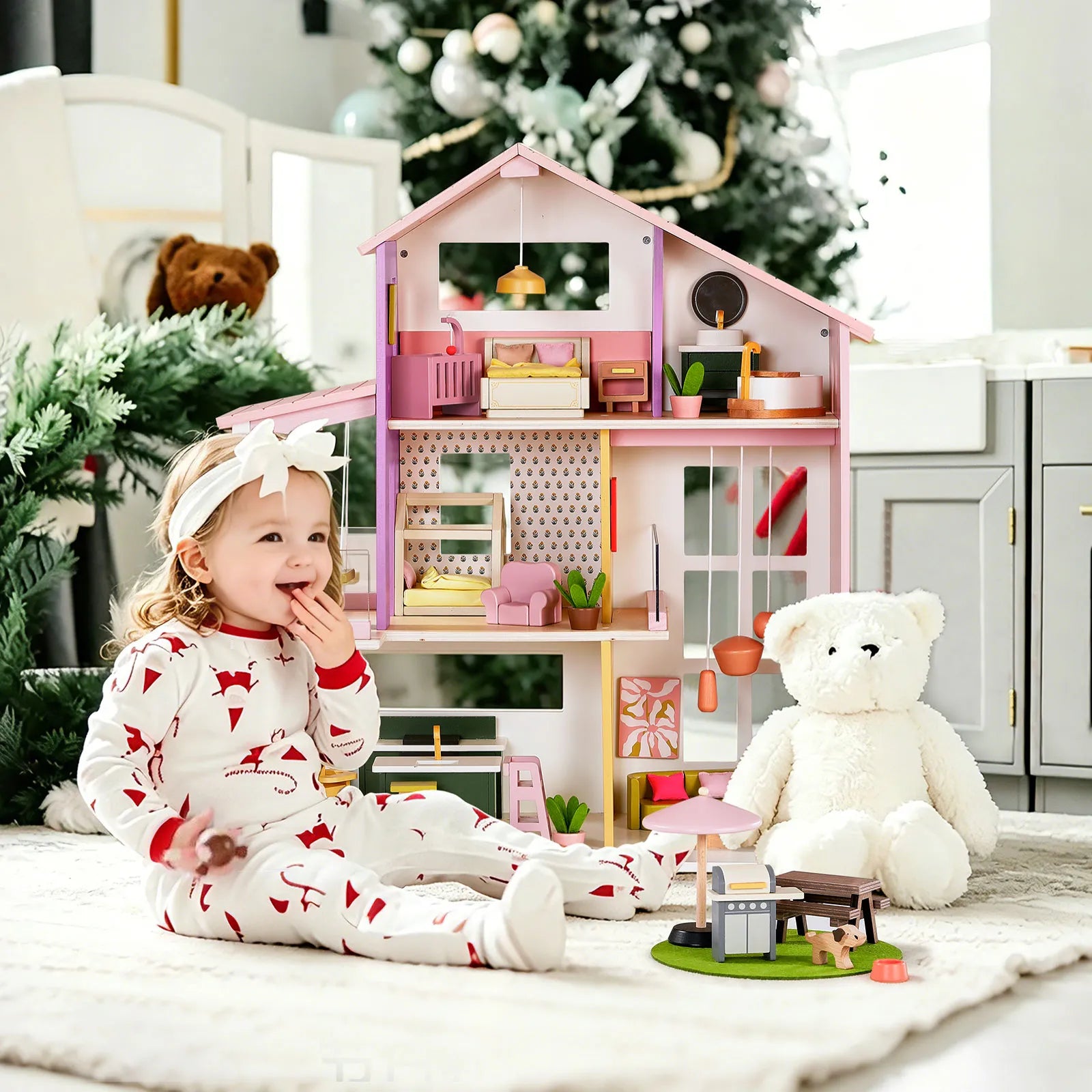 Child playing with a dollhouse and teddy bear in a cozy room with Christmas decorations.