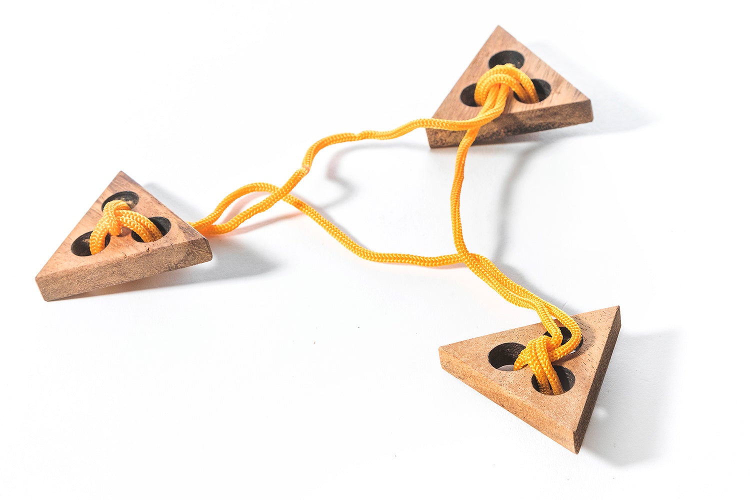 Wooden triangle-shaped toys with a yellow string on a white background