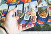 300-piece jigsaw puzzles from Oakland Puzzle Company with puzzle pieces held in a hand