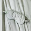Gray sleep mask on a white fabric background