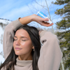 Teen using Pore Magic calming toner mist spray on face