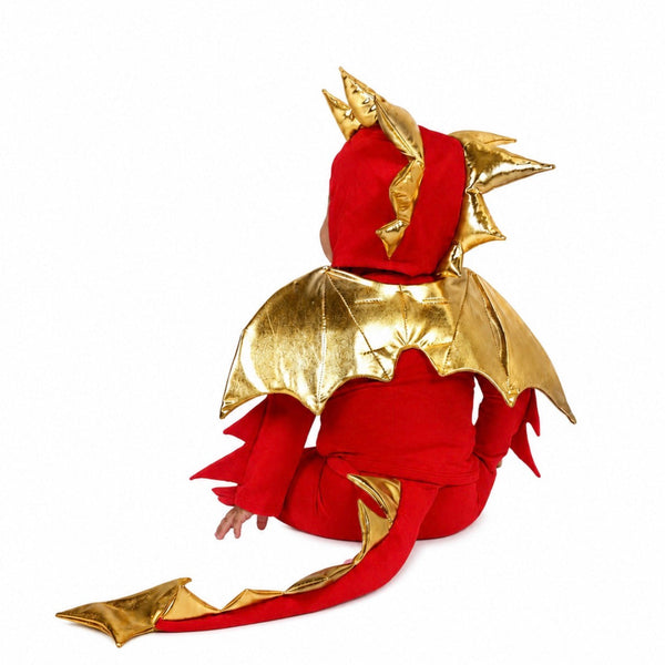 Child wearing the Baby Red Dragon Costume with shimmering golden wings