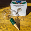 Blumat bottle adapter glass globe with packaging on a wooden surface