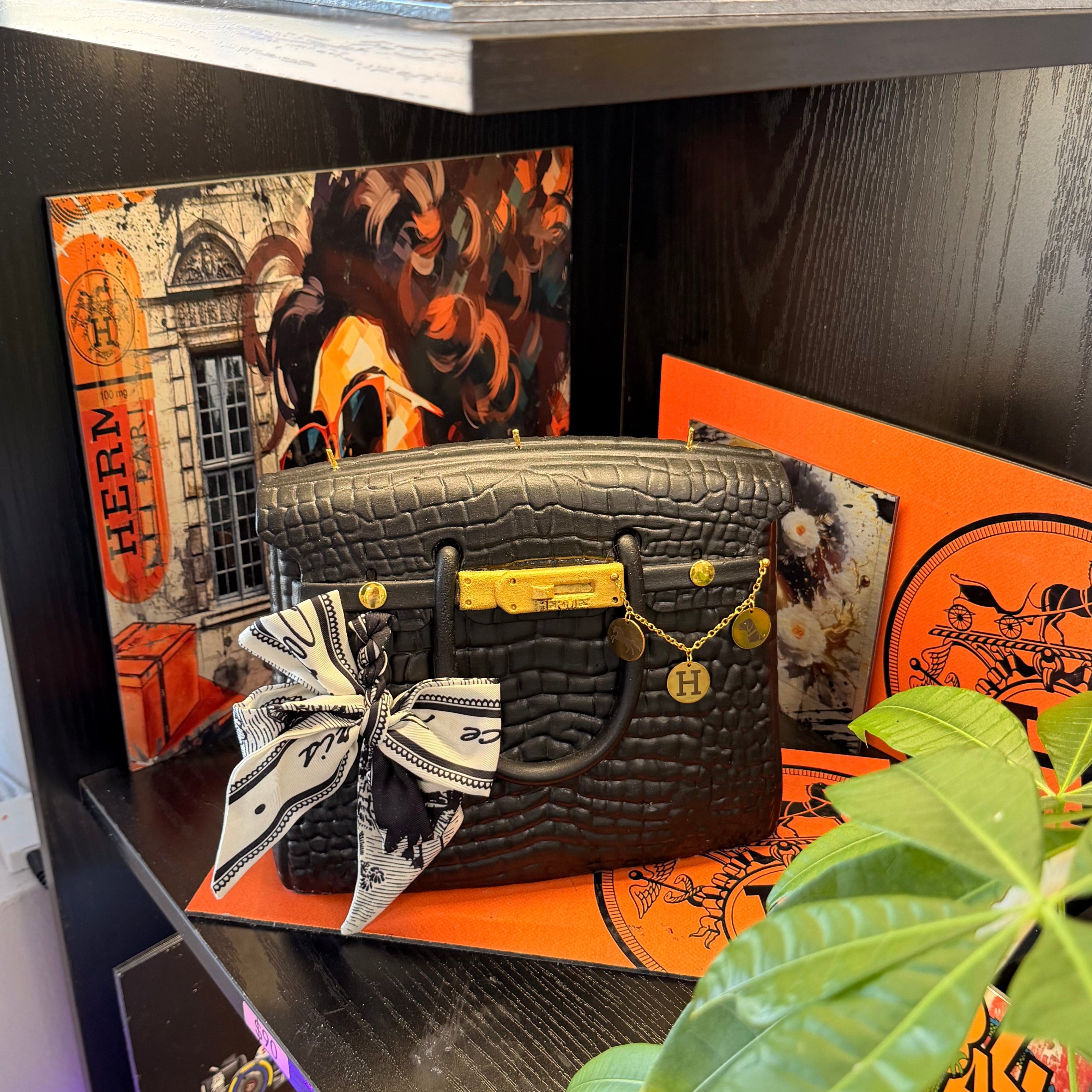 Close-up of the Onali Pure Black Large Iconic scented bag candle, showing sculptural handbag design in deep black finish