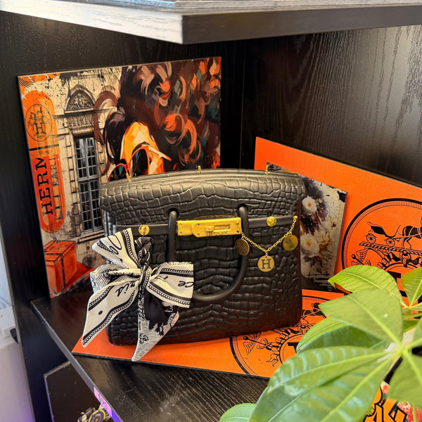 Close-up of the Onali Pure Black Large Iconic scented bag candle, showing sculptural handbag design in deep black finish