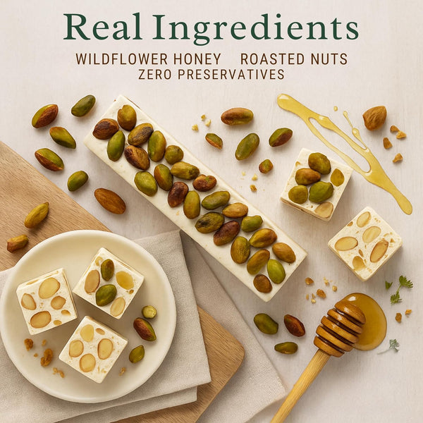 Honeycomb with roasted nuts on a light surface, accompanied by a honey dipper.