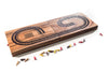 Wooden cribbage board with pegs on a white background