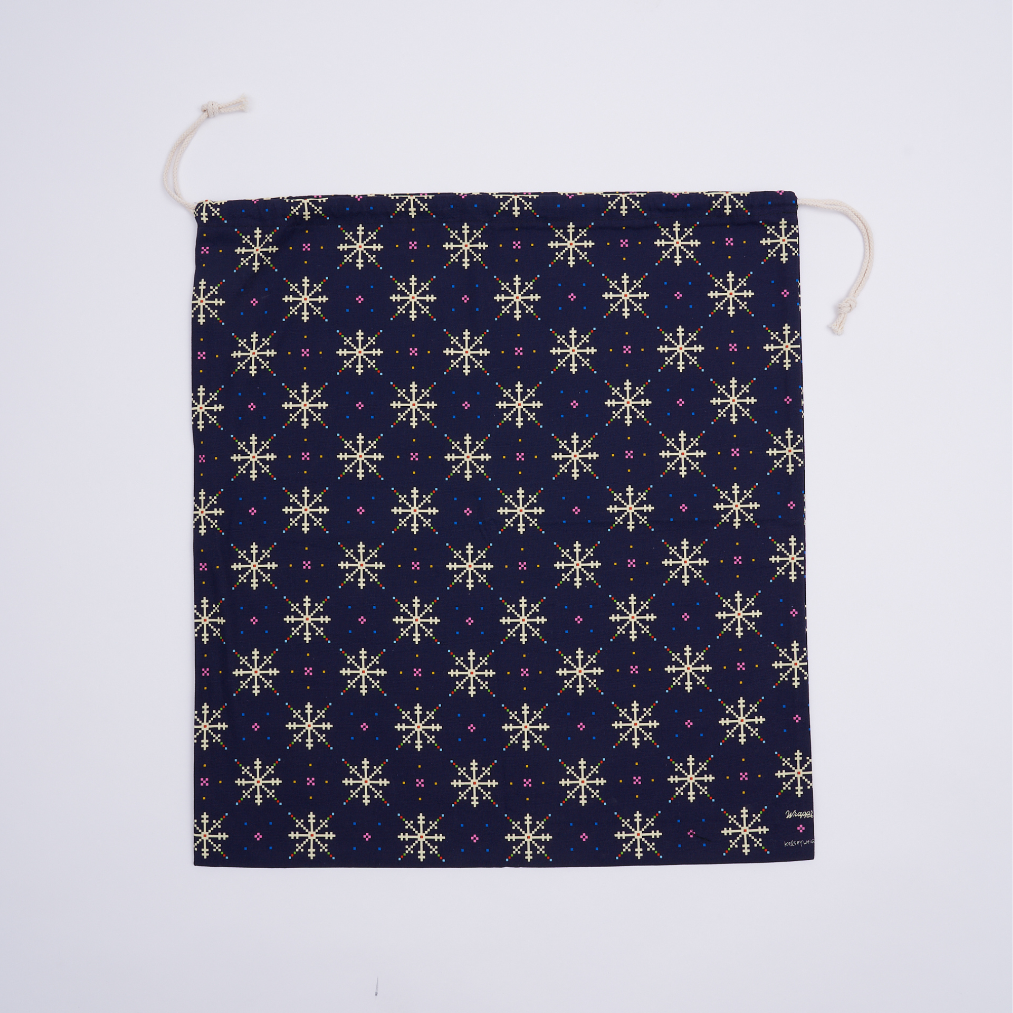 Flat lay of reusable Fair Isle cotton canvas gift bag as a zero-waste gift wrapping alternative