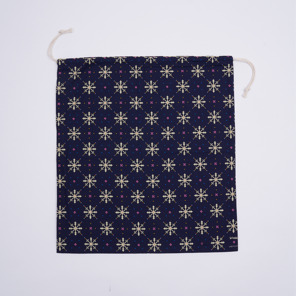 Flat lay of reusable Fair Isle cotton canvas gift bag as a zero-waste gift wrapping alternative