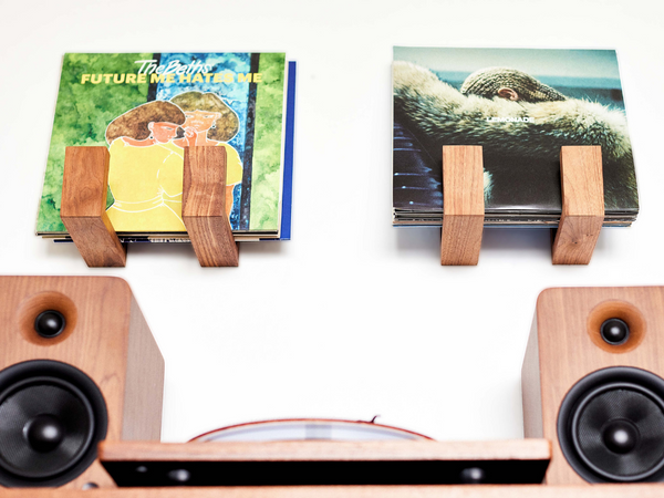 Deep Cut Flip Record Display Shelf brackets in walnut and hard maple on a white background