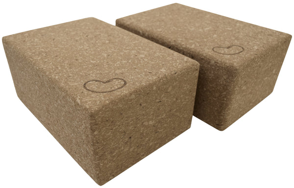 Set of two natural cork yoga blocks in 3-inch and 4-inch sizes on a white background