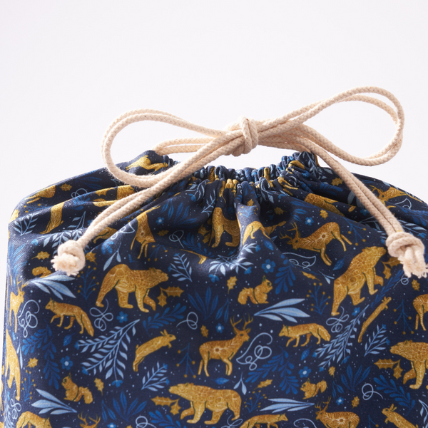 Side view of 14 by 18 inch cotton gift bag by Hannah Pearlman showing bag structure and handles