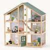 Wooden dollhouse with multiple rooms and furniture on a white background