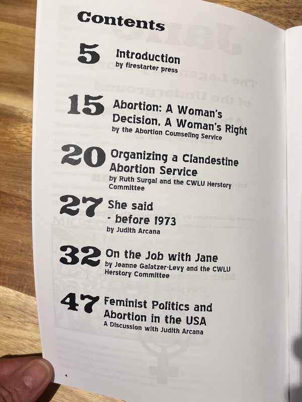 Inside spread of the Jane zine open to the table of contents, on a wooden surface