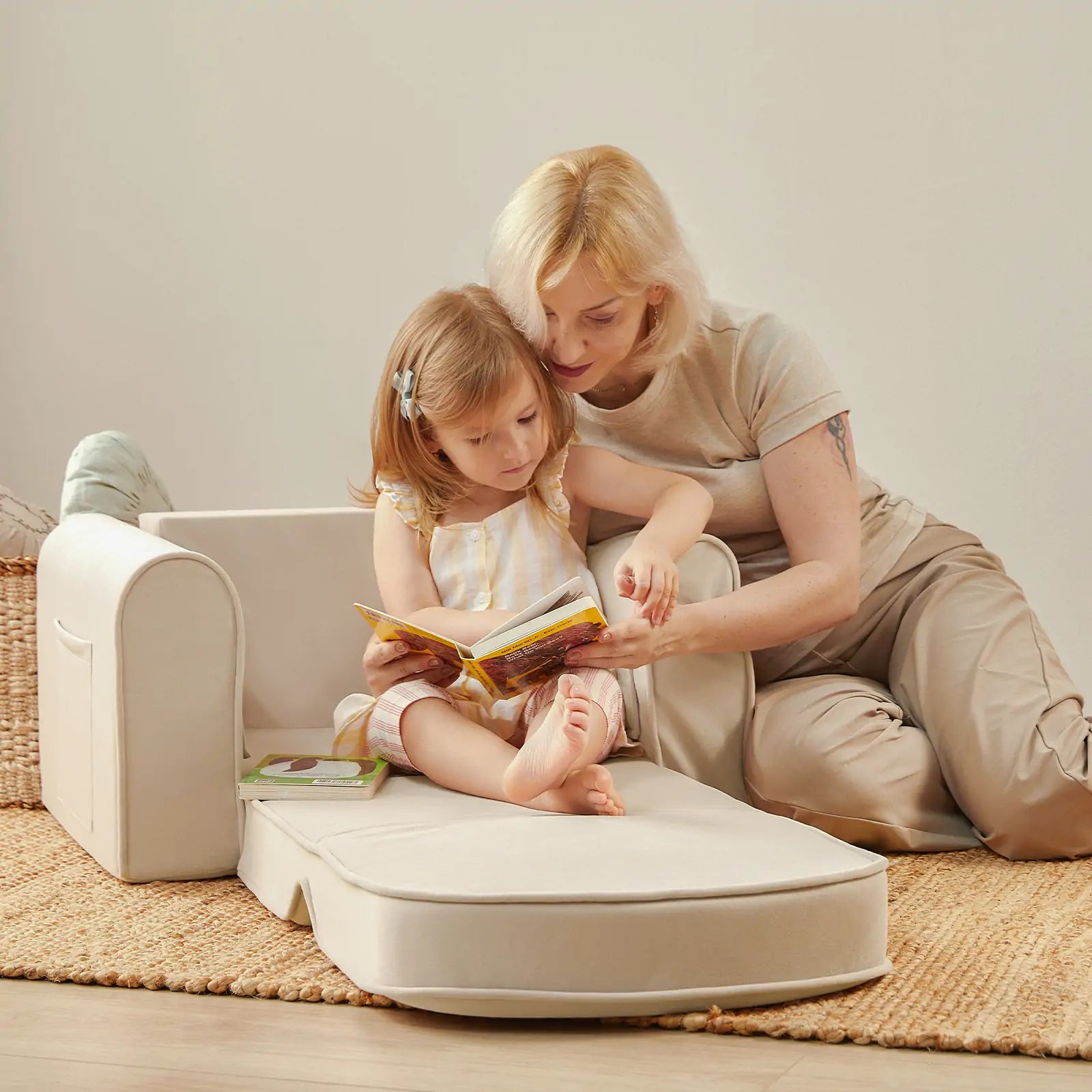 Tiny Land foldable toddler sofa chair with easy-carry handle, shown in beige white in a playroom setting