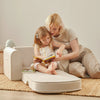 Tiny Land foldable toddler sofa chair with easy-carry handle, shown in beige white in a playroom setting