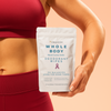 Person holding a package of Freedom Whole Body deodorant wipes against a peach background
