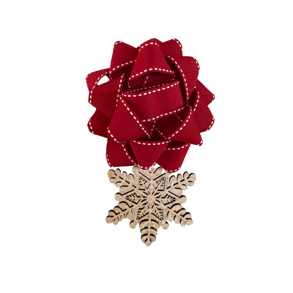 Close-up of EverWrap wooden snowflake charm for sustainable holiday gift wrapping