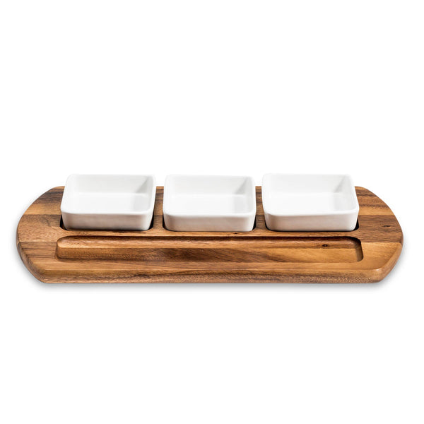 Wooden tray with three white ceramic dishes on a white background