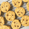 Chocolate chip cookies on a cooling rack with a light gray background