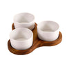 Three white ceramic bowls on a wooden tray against a white background