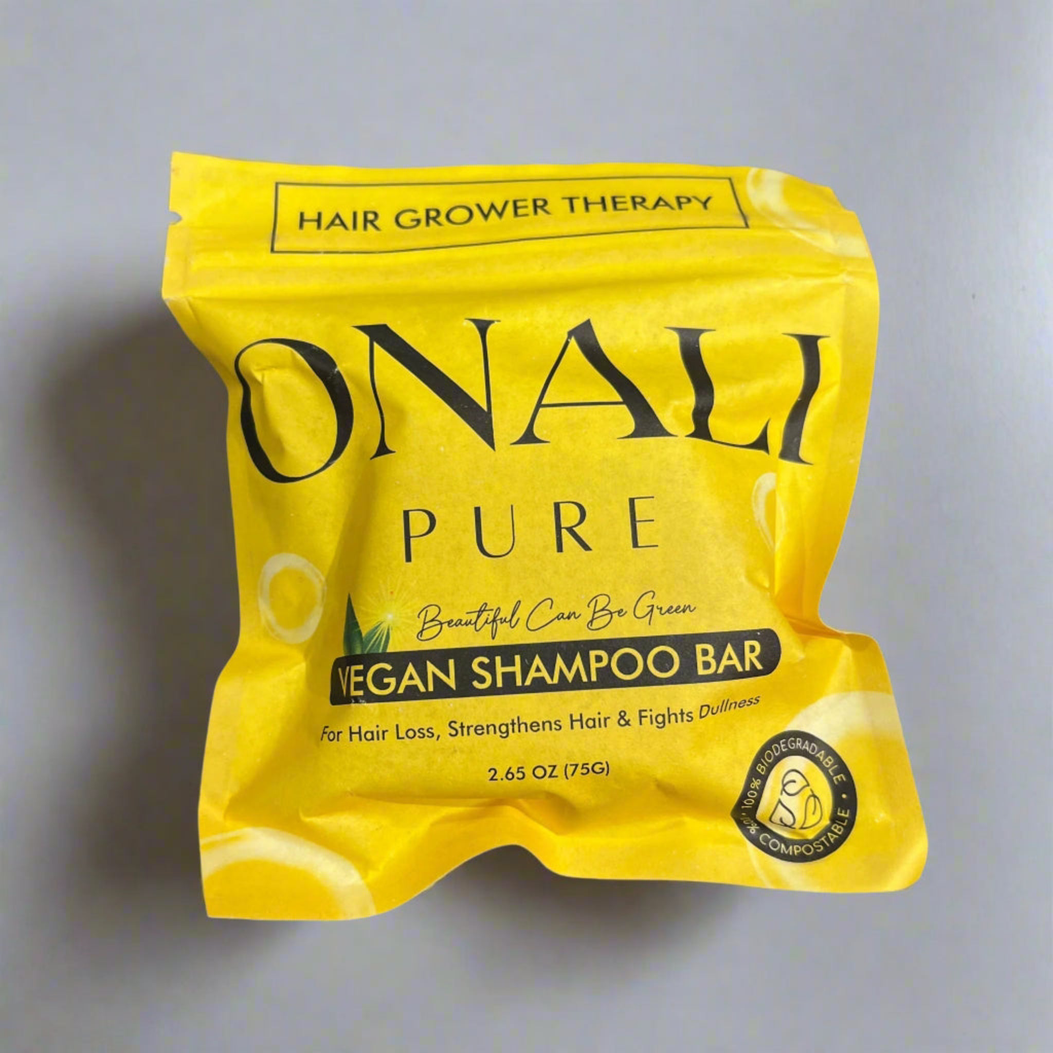 Yellow package of ONAY Pure Vegan Shampoo Bar on a gray surface
