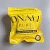 Yellow package of ONAY Pure Vegan Shampoo Bar on a gray surface