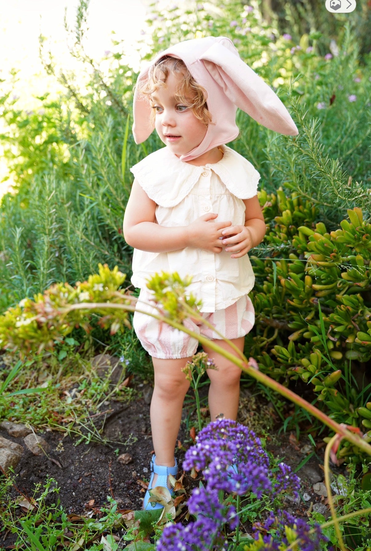 Child wearing the Pink Bunny Bonnet with snap closure under the chin