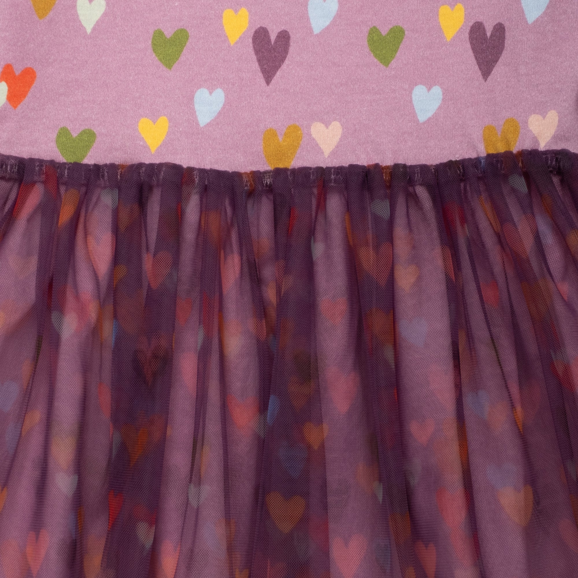 Close-up of the Mini Hearts Tulle Dress by Mon Coeur showing the heart print and tulle skirt layers