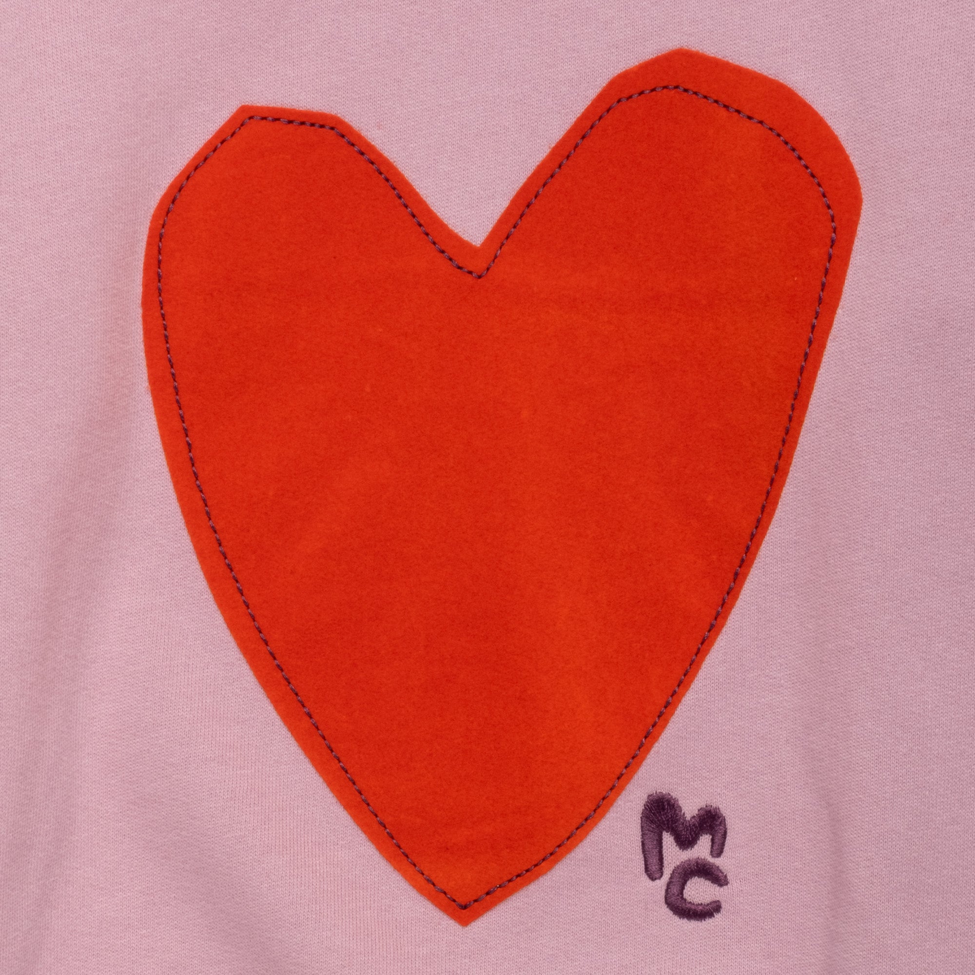 Close-up of the handcrafted-inspired felted heart appliqué on the Mon Coeur Kids Sweatshirt