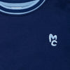 Close-up of Mon Coeur Kids MC Navy Sweatshirt showing signature MC logo and rib trim detail