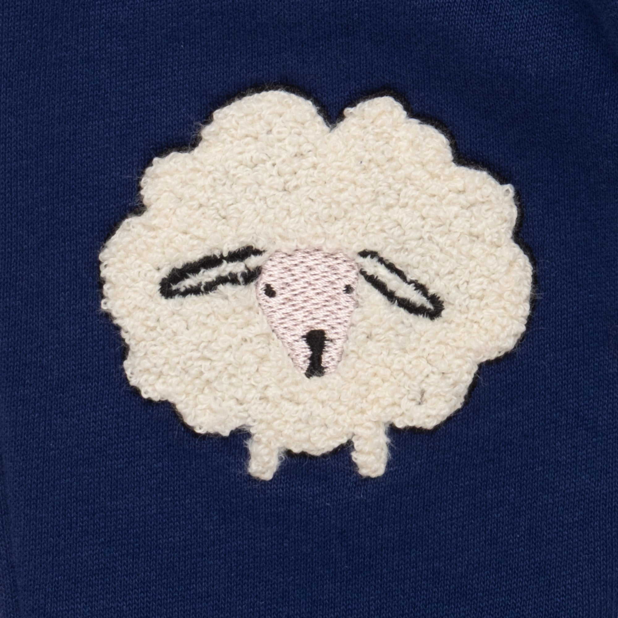 Close-up of the boucle sheep knee appliqué detail on the Mon Coeur Cozy Sheep Jogger