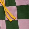 Close-up of the Mon Coeur Kids Green Checkered Jogger showing the bold checkerboard print and tapered fit