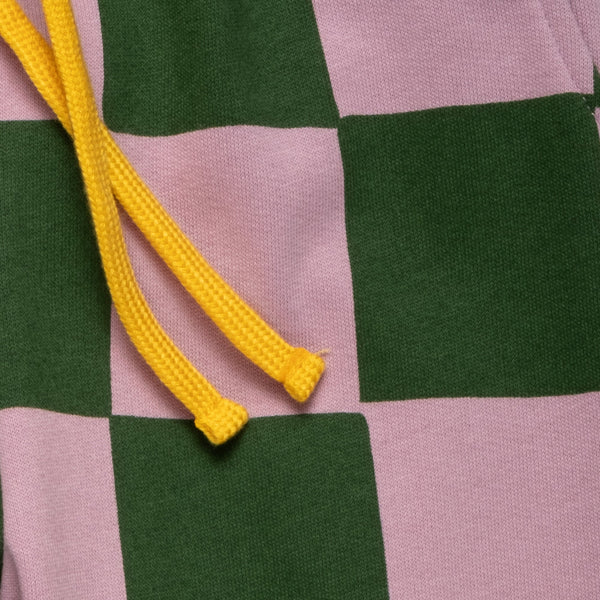 Close-up of the Mon Coeur Kids Green Checkered Jogger showing the bold checkerboard print and tapered fit
