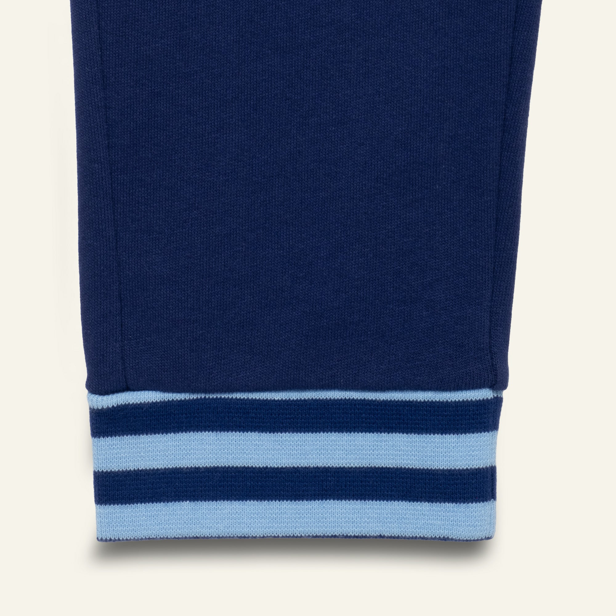Close-up of a blue sweatshirt with light blue stripes on a white background