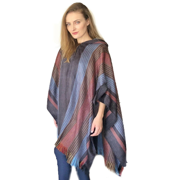Close-up of the six-band alpaca poncho's layered stripe pattern in rich, earthy tones