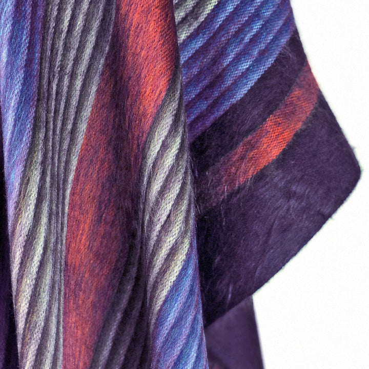 Side view of the Six Band Alpaca Poncho draping over a relaxed everyday outfit