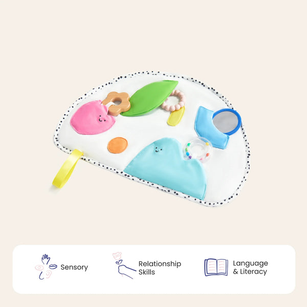 Colorful baby toy with various shapes and textures on a beige background