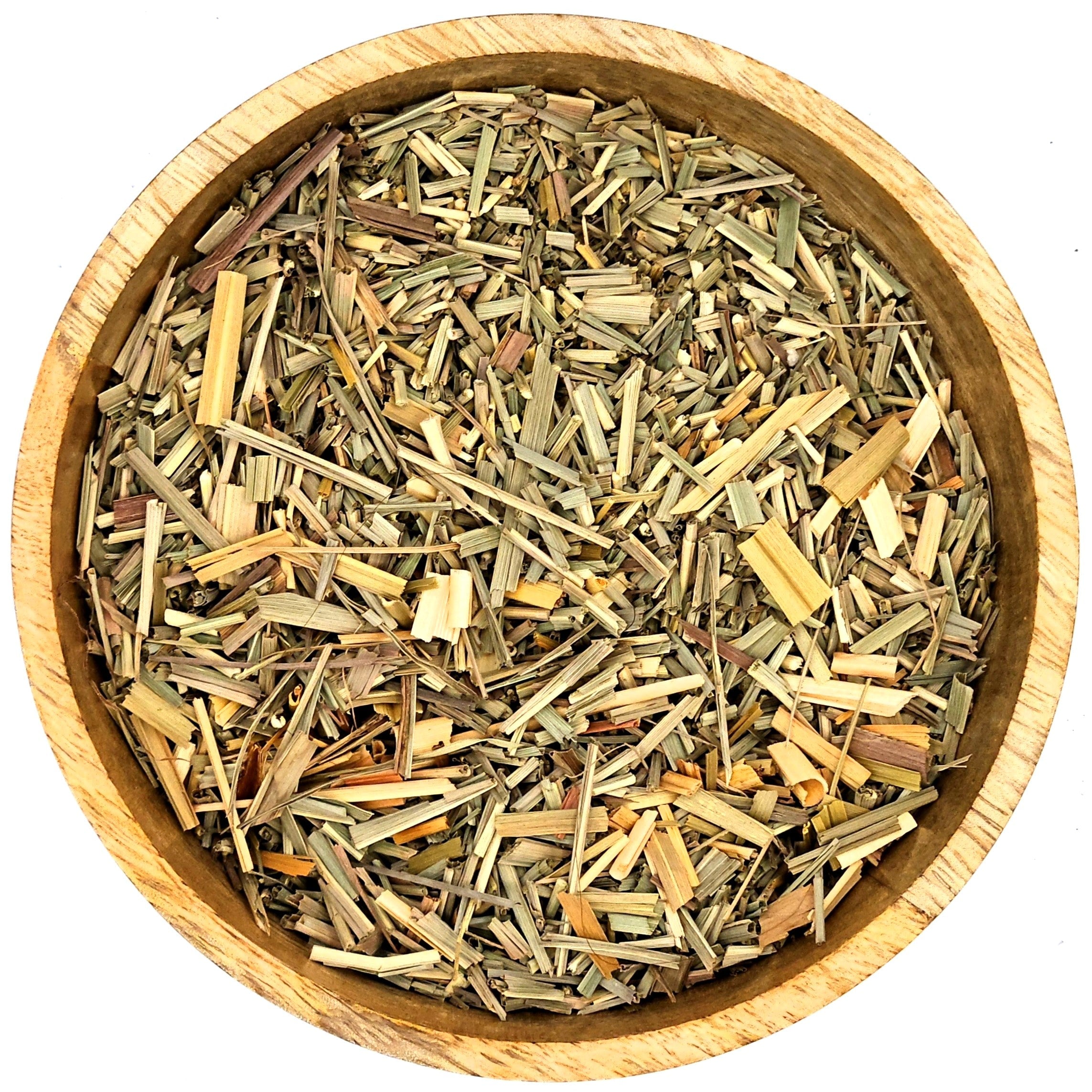 Wooden bowl filled with dried herbs on a white background