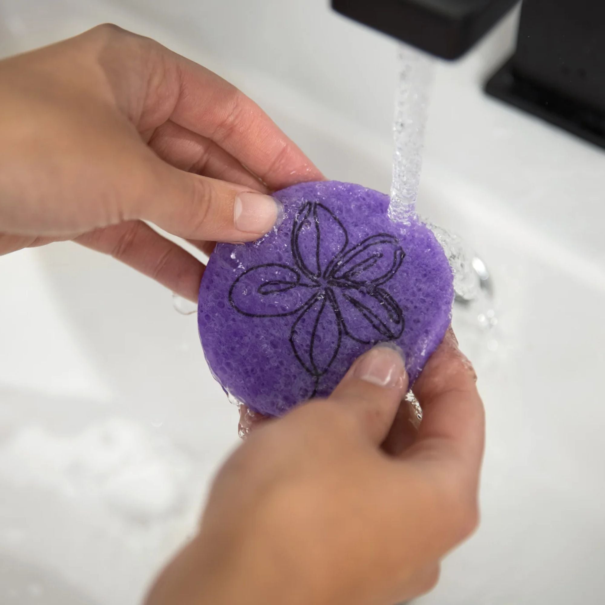 Purple Plumeria compostable facial sponges in travel canvas bag — eco-friendly skincare set