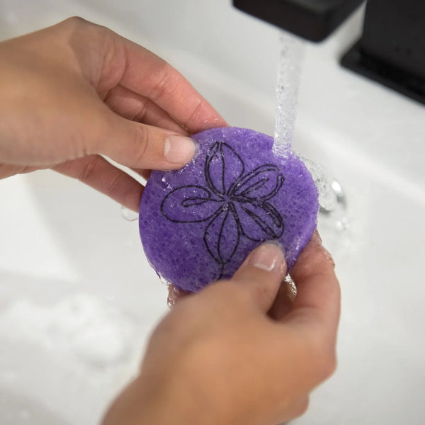 Purple Plumeria compostable facial sponges in travel canvas bag — eco-friendly skincare set